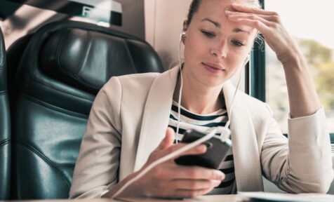 woman looking at phone in train